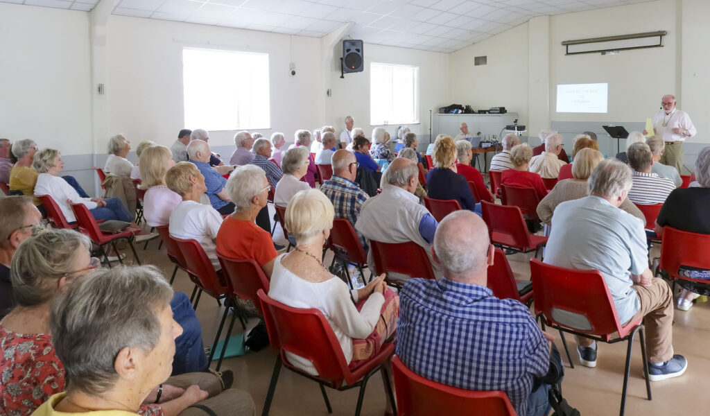 View of Mervyn Edwards addressing Windsor u3a at July's Monthly Meeting