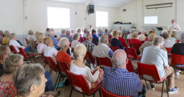 View of Mervyn Edwards addressing Windsor u3a at July's Monthly Meeting