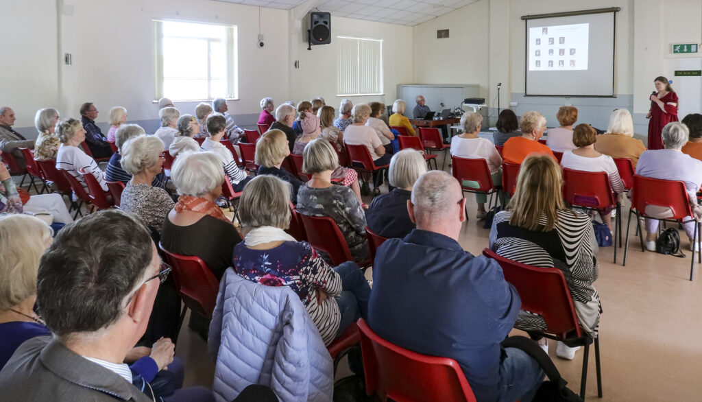 Hampton Court guide Sarah Slater relating history to our May 2024 audience.