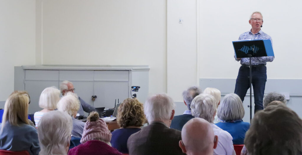 Poet Clive Woodward presenting to our July 2024 meeting.